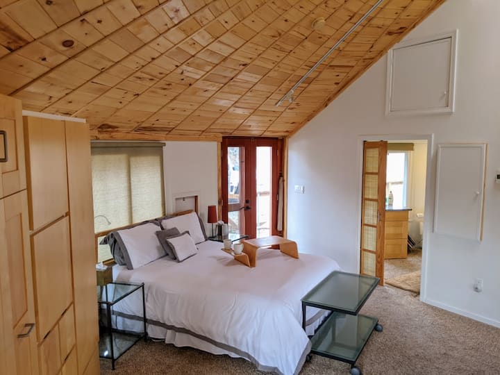 Queen-sized bed with private bathroom just off the side. 