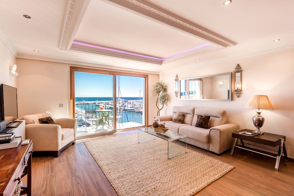 Nice living and dining room with plush sofa and great views in Puerto Banus, Marbella