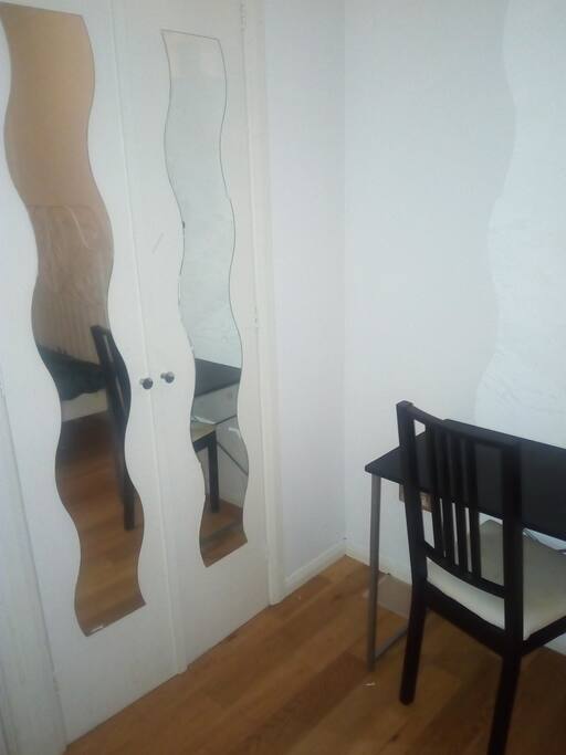 Wardrobe, desk and chair at the room.