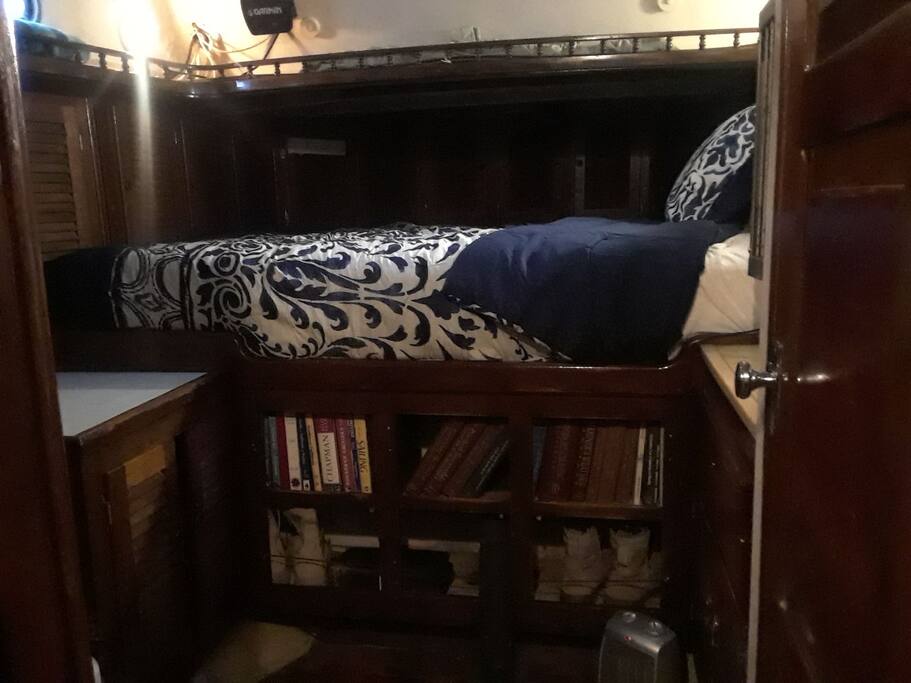 master cabin with queen bed, sink, bathroom and shower.