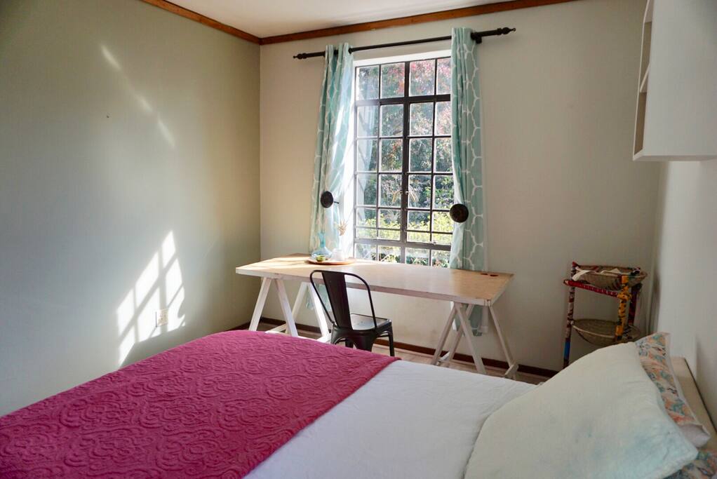 1st view of private guest room; double bed (100% cotton linen, chiropractic bed), desk with a view.