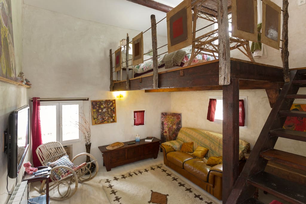 TV room with double bed mezzanine above it