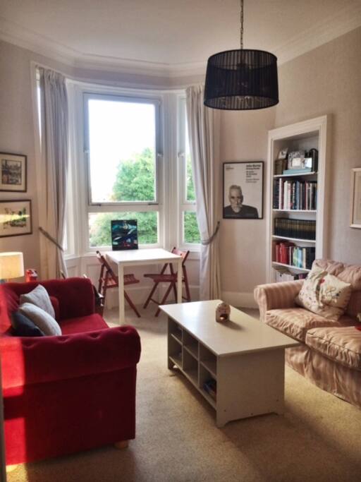 Living room. Two comfy sofas, small dining table, television and DVD player and record player.