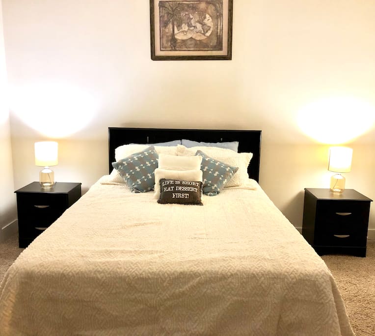 Master bedroom with comfy queen size bed, night stand and dresser.