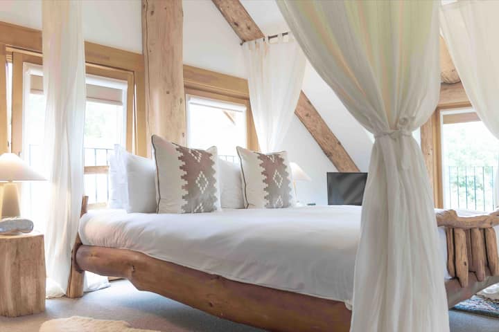 Master bedroom with super king size comfortable bed, fluffy pillows and duvet, extra sofa bed and luxury freestanding bath open to the eaves and direct view of Ben Nevis.