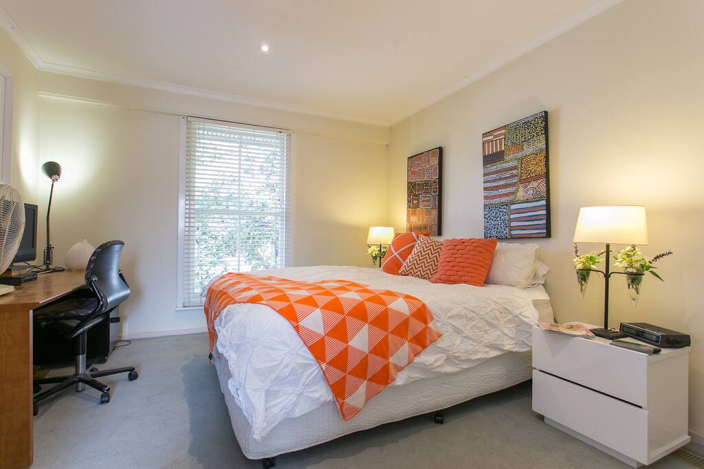 The Bedroom overlooking an oak tree & the street .