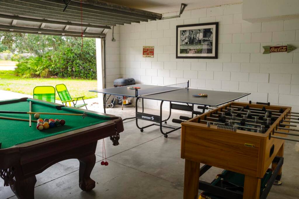 Games area with pool table, foosball and table tennis.