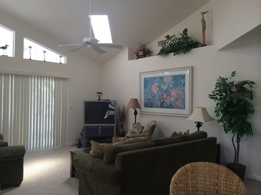 Main living room area with double sliders to the screened in front lanai.