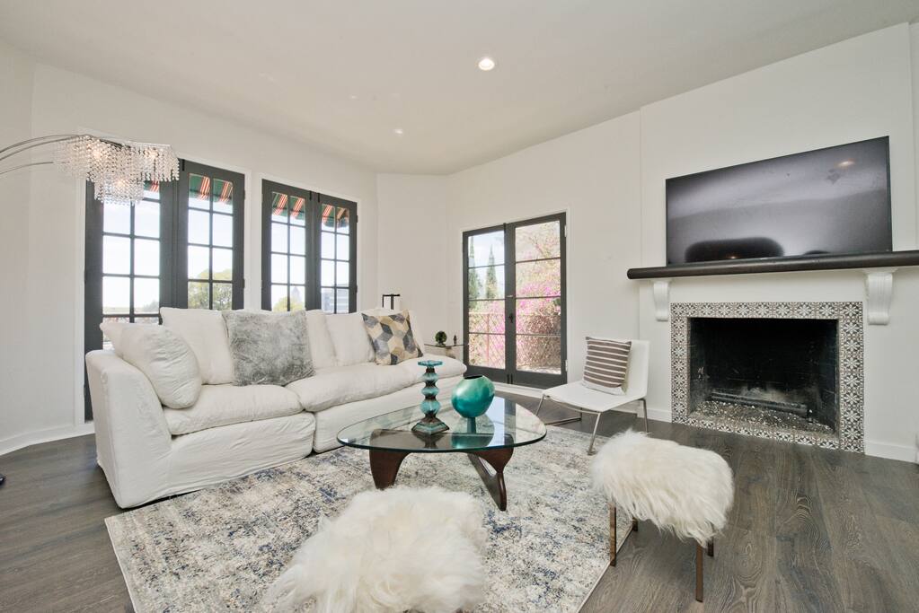 Doors open to balconies with views and tables, fireplace, HDTV, Cloud Sofa with down pillows