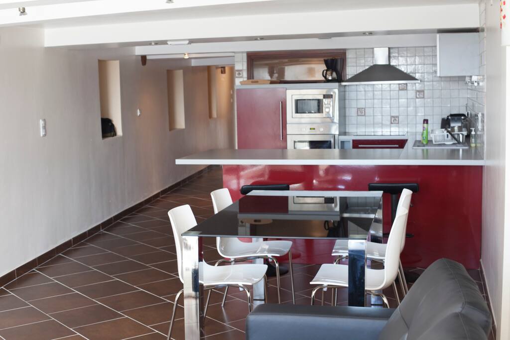 Une grande cuisine aménagé et son coin repas