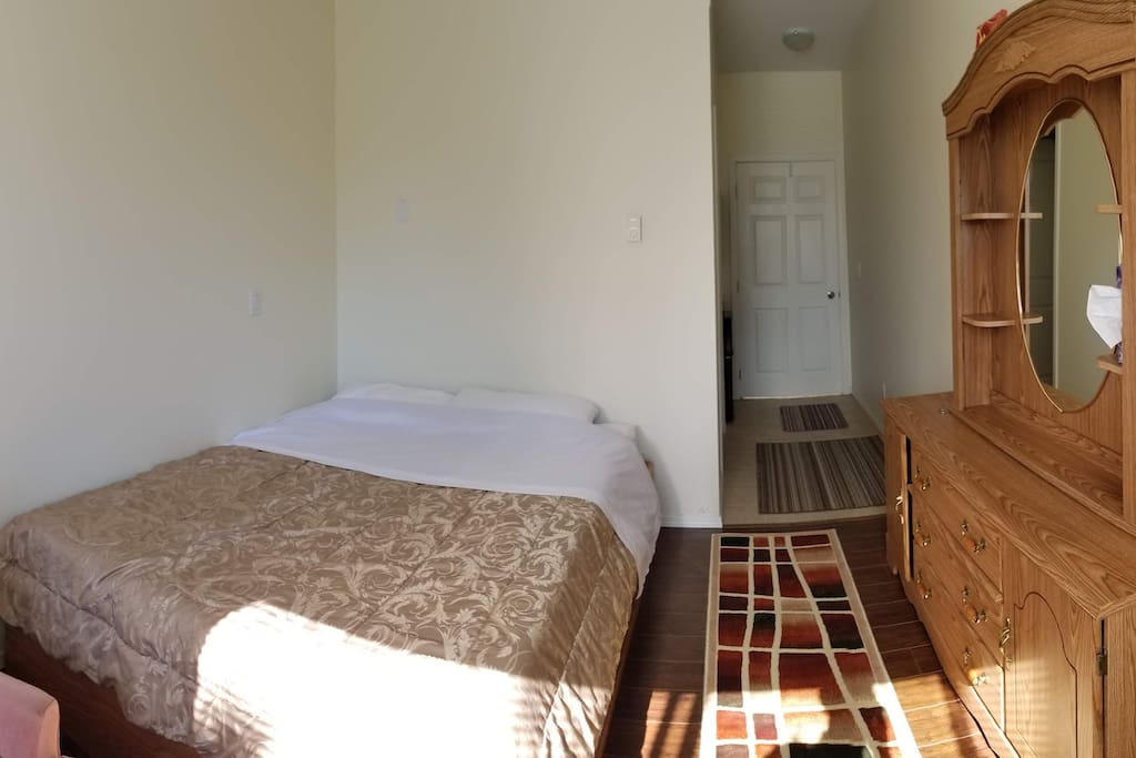 Bedroom with private washroom and kitchenette.