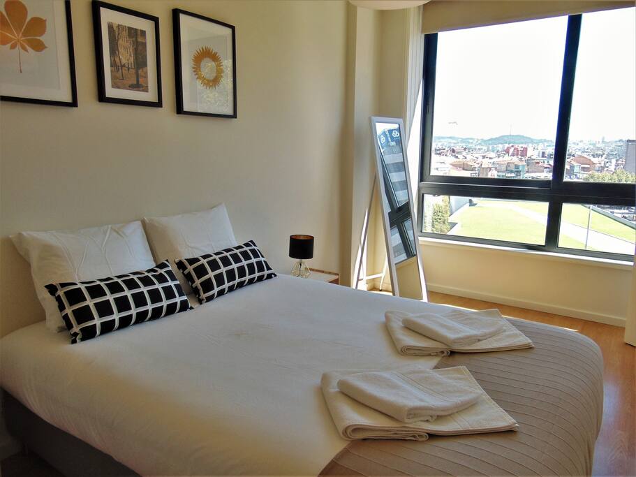 The bedroom with the view to the city centre