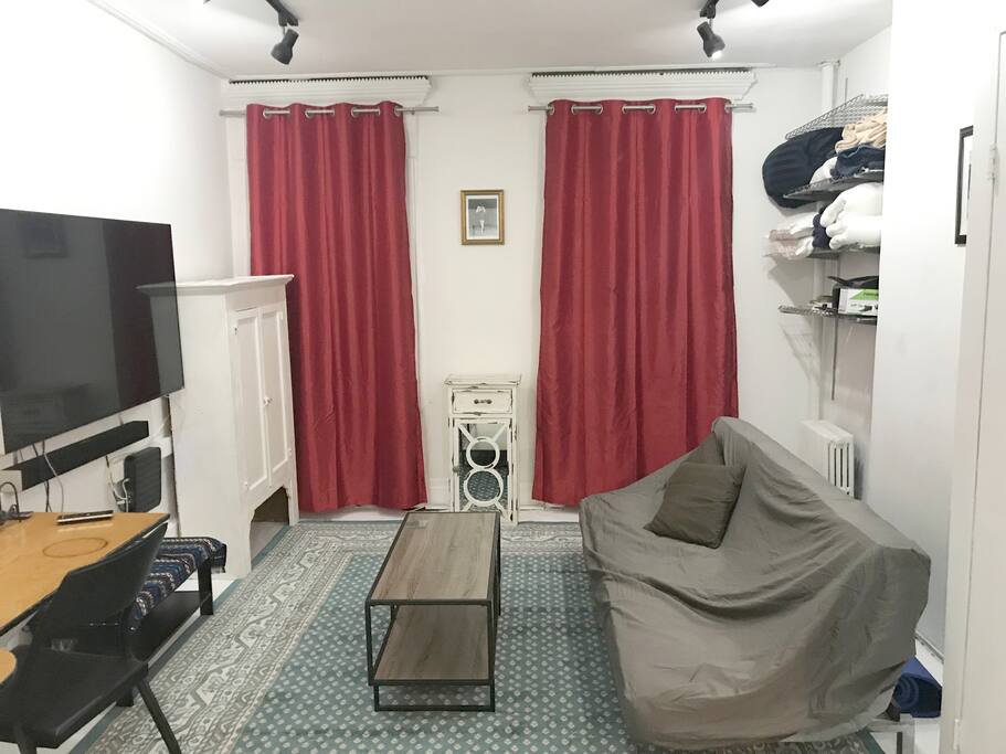 Living room showing new curtains, new coffee table and new white wood floors with a new rug. Big upgrade.