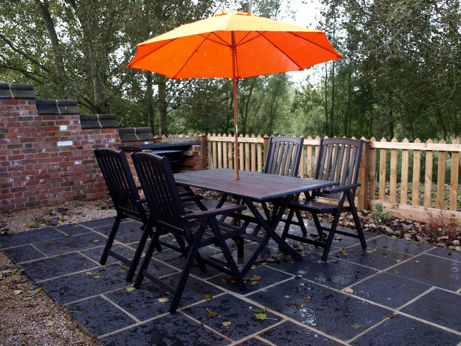 The patio area with built in B.B.Q and seating - plus use of grounds