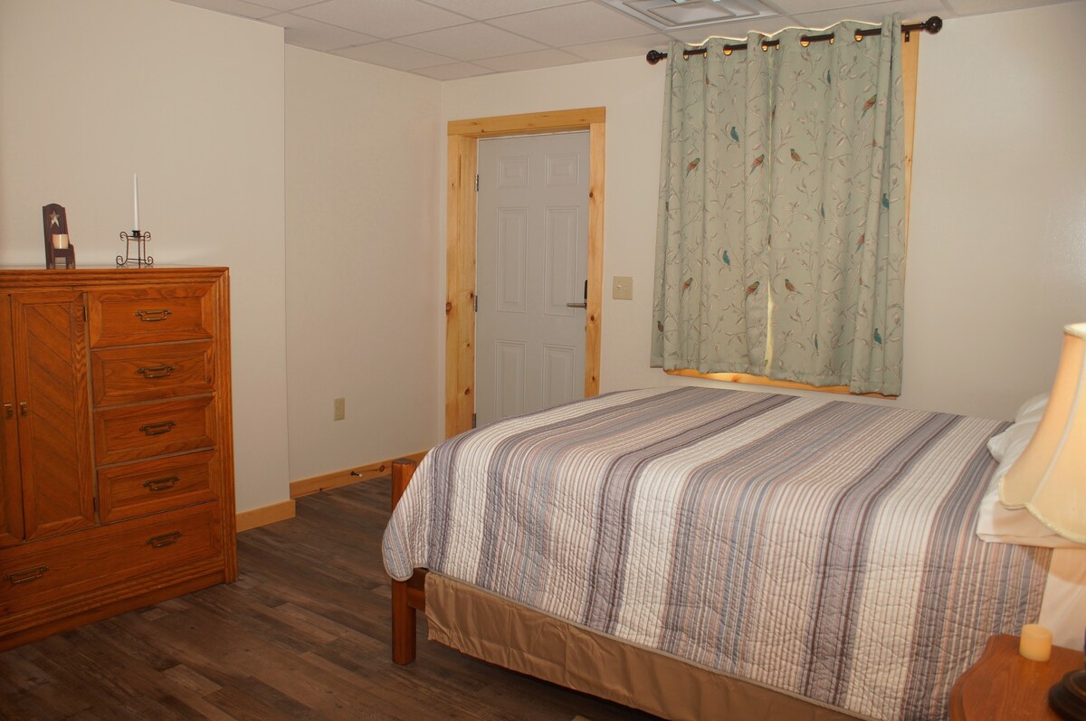 Queen bedroom #2 with chest and ground floor exterior door.