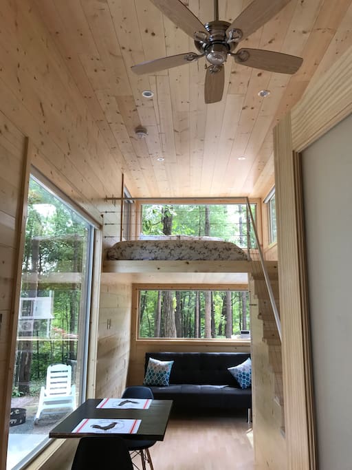 View of loft, giant windows, ceiling fan, interior dining and living space