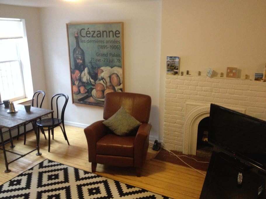 The apartment receives incredible light. Enjoy it while you perch on the rocking chair next to the fireplace.