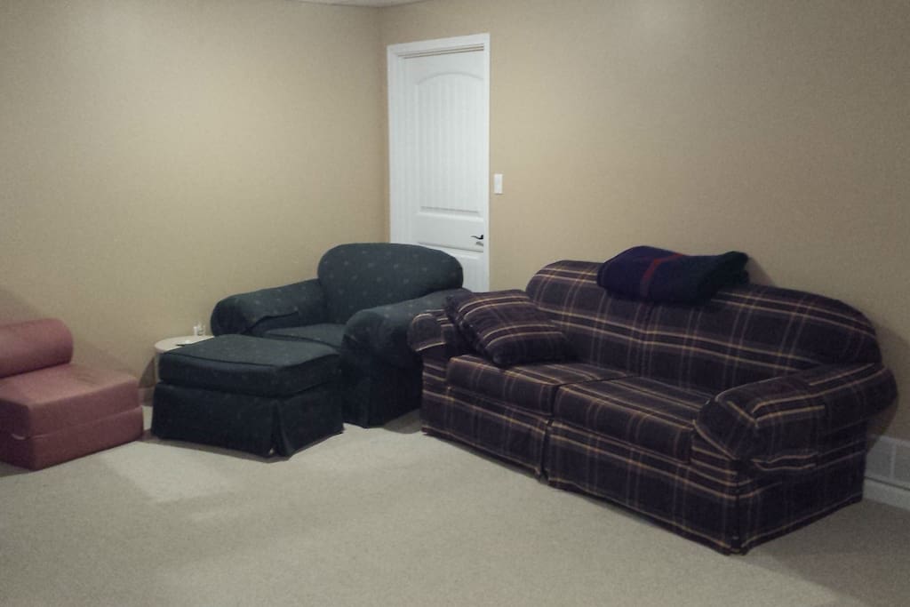 The main living area offers the comfort of a couch, chair and other amenities.