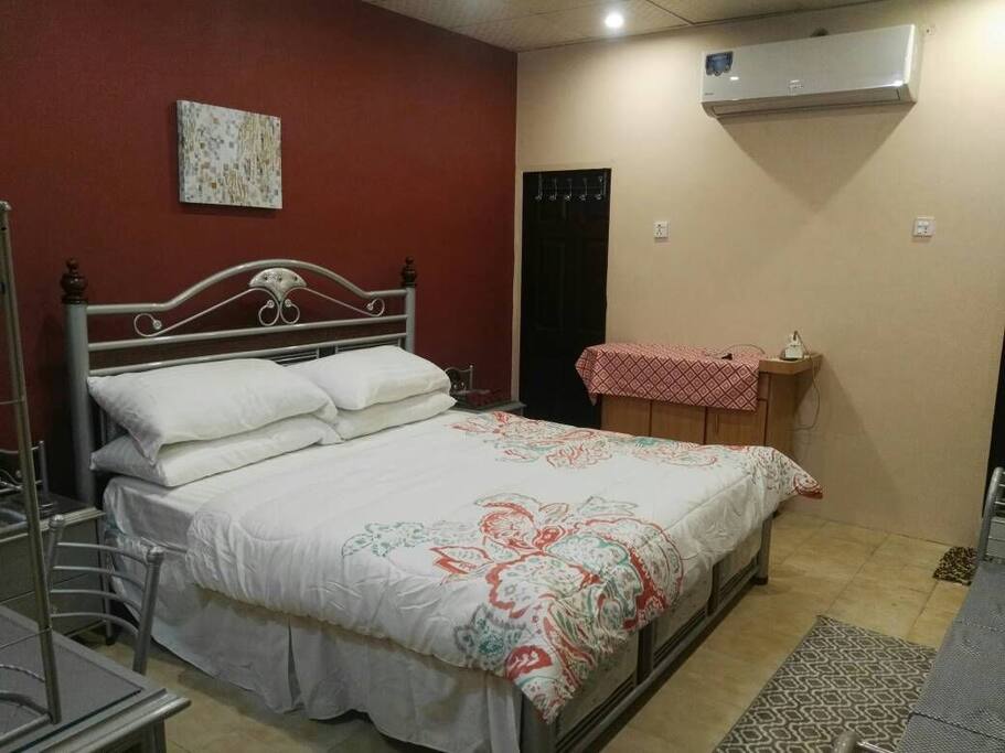 bedroom with Air condition, ironing board, iron and access to walk in closet