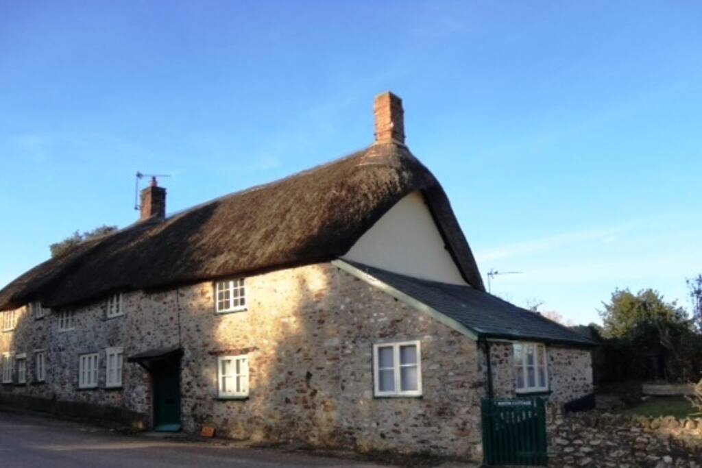 Batts Cottage with green door is one half of a larger house.
