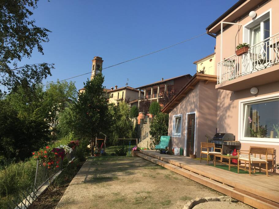 View from the garden to the dwellings and church tower of Serravalle Lange