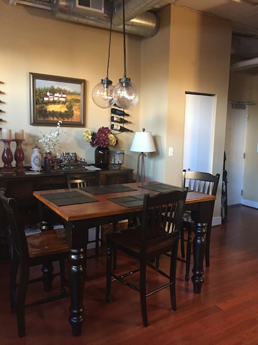 Table accommodates up to 6 (with dining table leaf.) And yes, the wine looks awesome. Please just look!