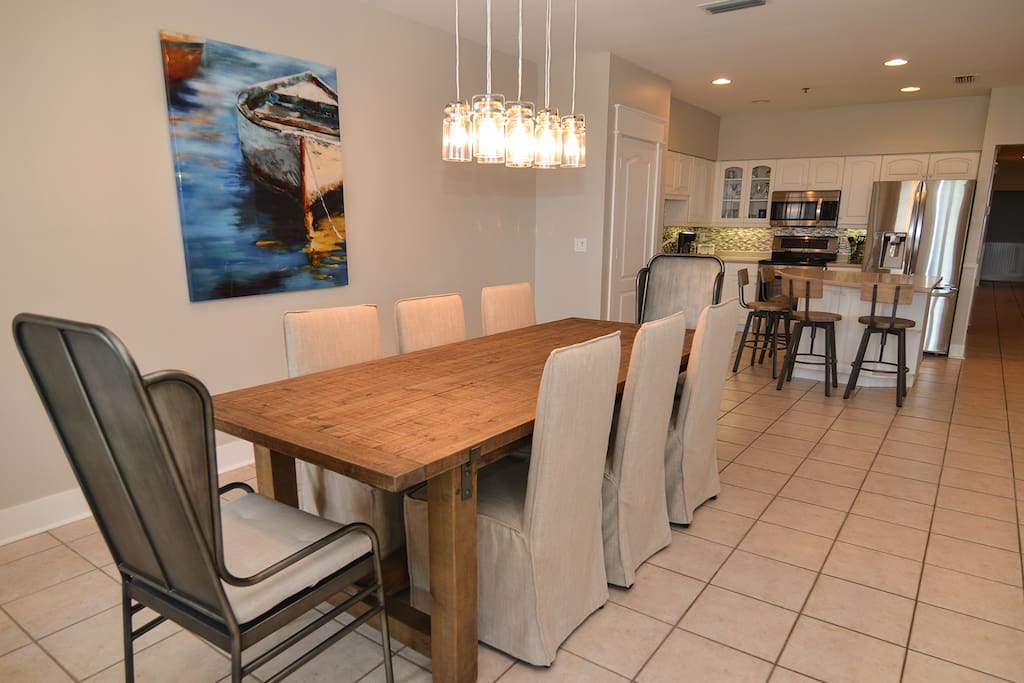 Dining area affords eating space for eight with additional seating for four at the kitchen island