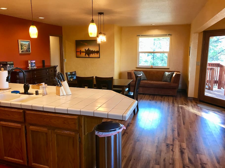 Kitchen / Dining Room area. All new appliances, counter seating, dining table, and breakfast bar seat a total of 12. Additional folding card table, folding long table and padded folding chairs available for more seating.