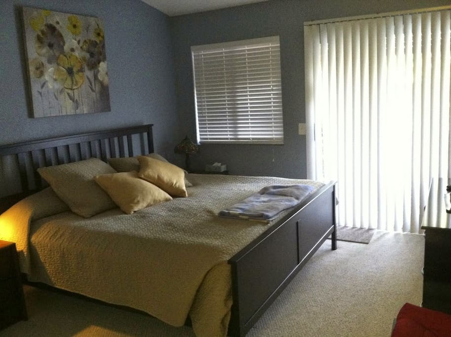 Comfortable King Size bed with crisp, high quality bedding in a quiet, vaulted ceiling master bed/bath room.