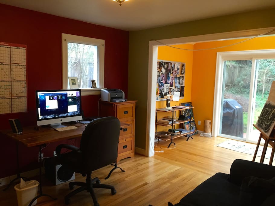 The den connect to the sunroom/studio with the deck beyond.