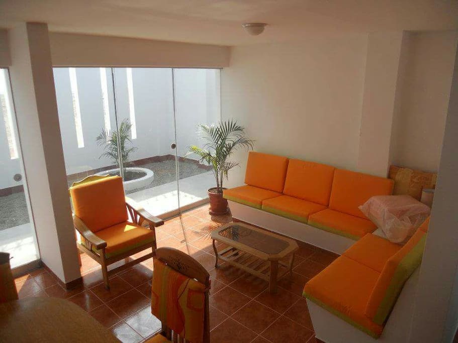 Living rooms are simple chic and comfy.
