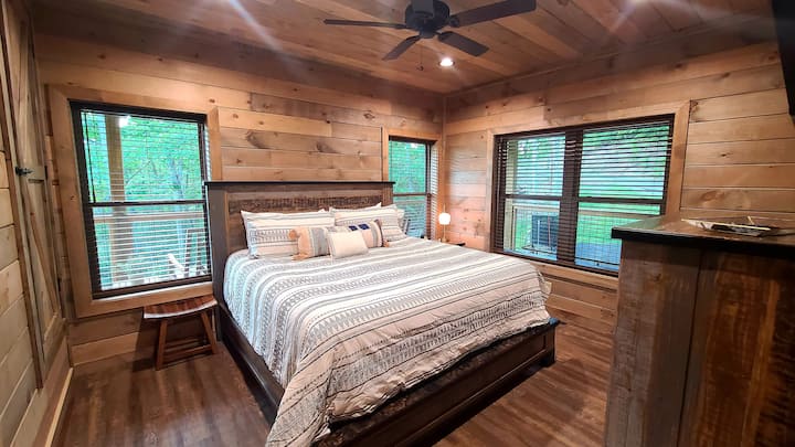 Upstairs bedroom with king sized bed and ensuite bathroom.