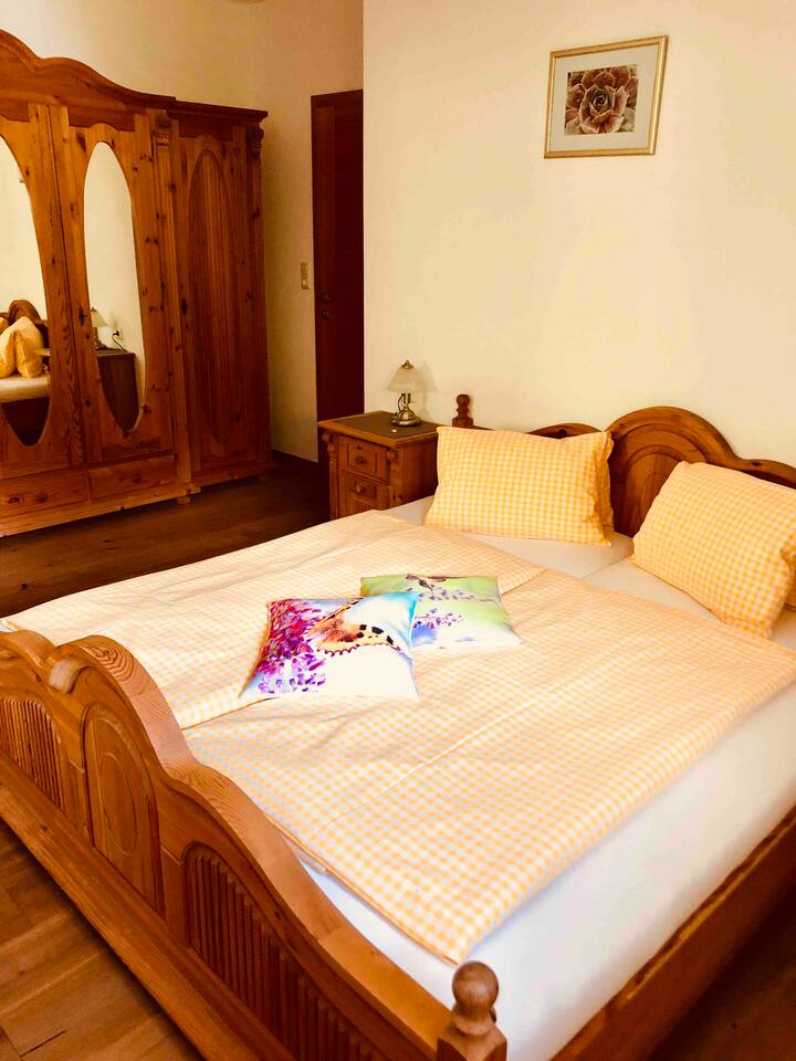 سرير أنيق على طراز شجرة التنوب مع خزانة ملابس كبيرة، بالإضافة إلى ذلك، تضمن الأرضية الخشبية الطبيعية مناخًا لطيفًا للغرفة.