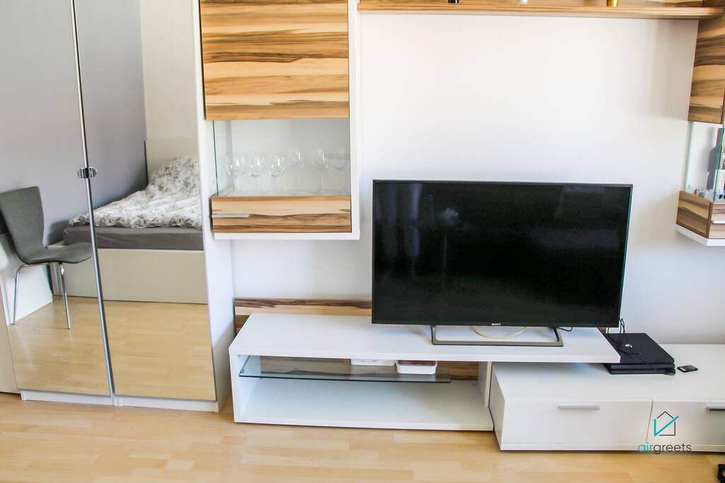 Feel free to use the modern TV for watching a good movie.