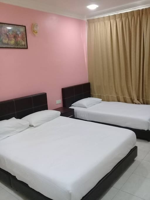 a private room with a double bed and a single bed
