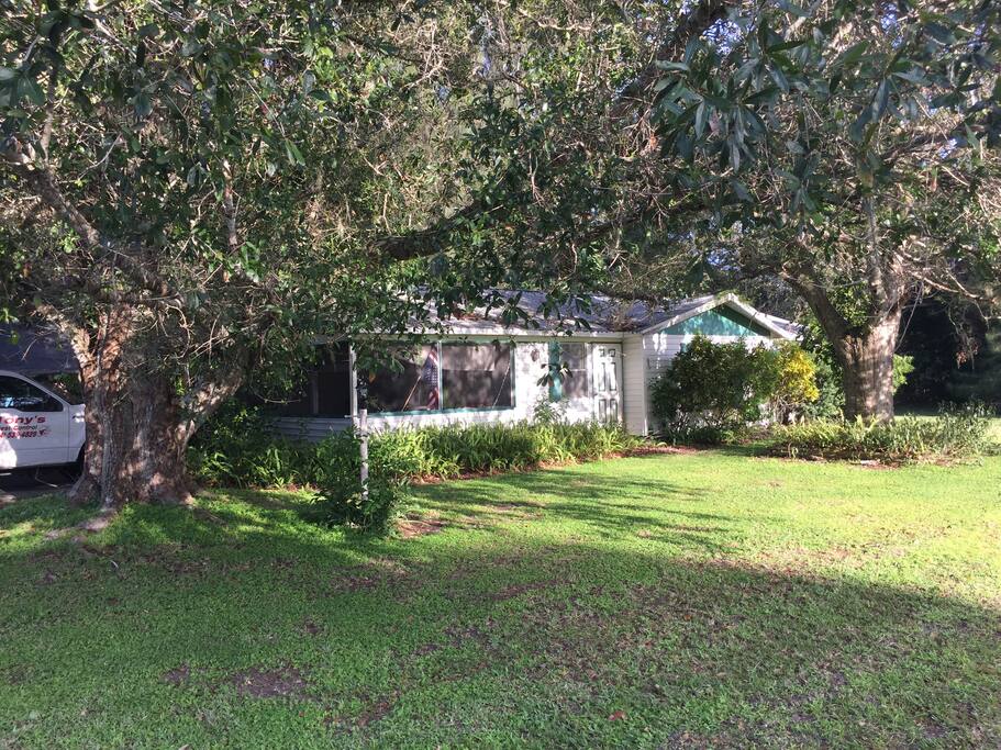Front outside of home nestled around all the trees.