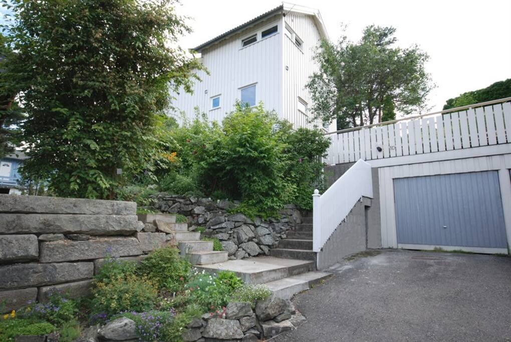 The house from the driveway. The apartment is on the upper floor.