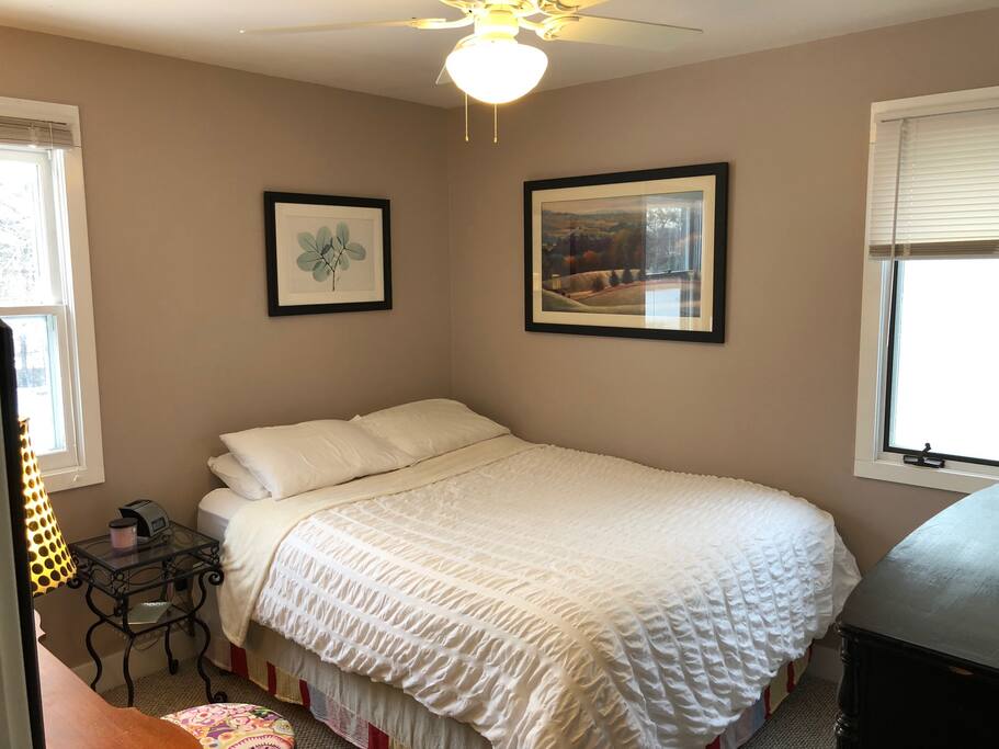Bedroom 2 has a queen bed and a vanity with large mirror to sit at to do hair/makeup.