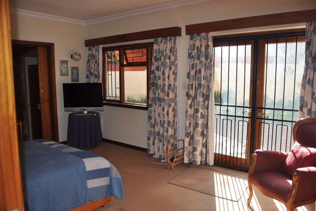 Spacious sunny room leading off to private garden setting.