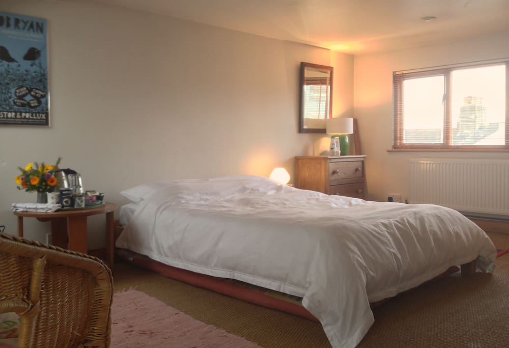 Loft room with comfortable double bed with plenty of space for travel cot.