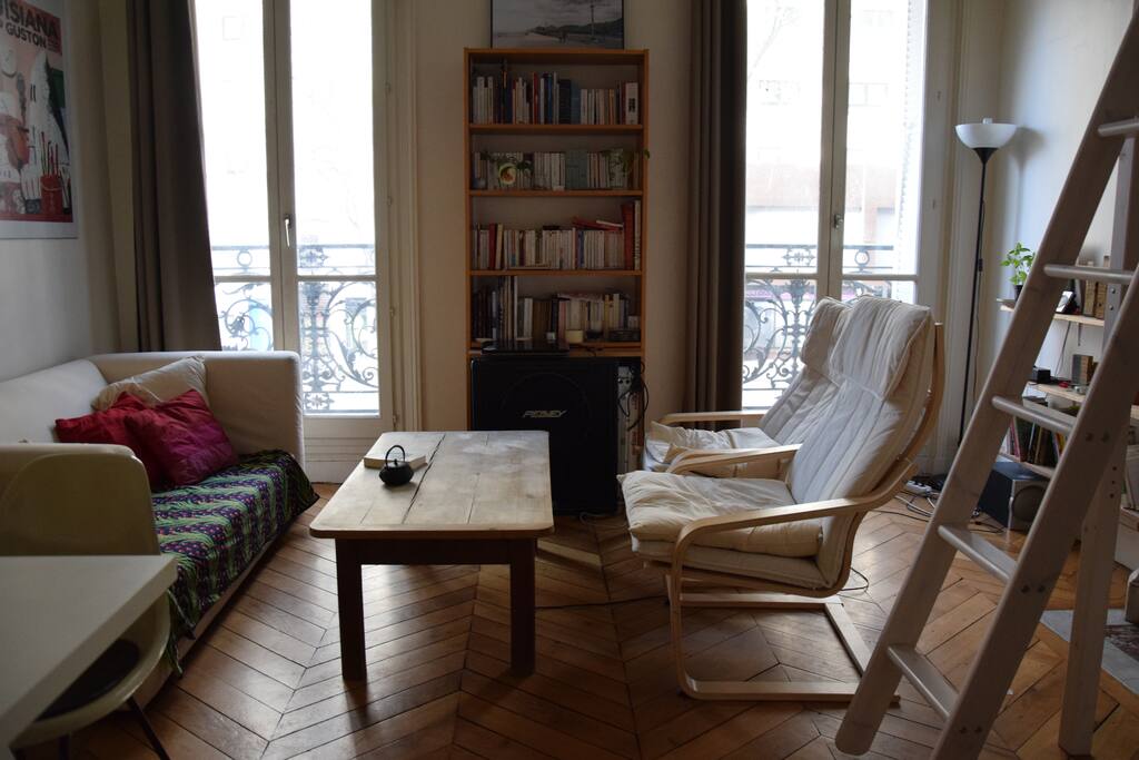 Bright and cosy living room with different books and board games