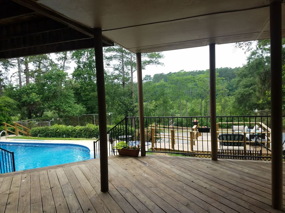 Lower level deck looking out towards pool and lake