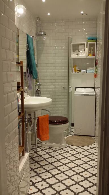 Newly renovated bathroom with shower, washing machine and floor heating.