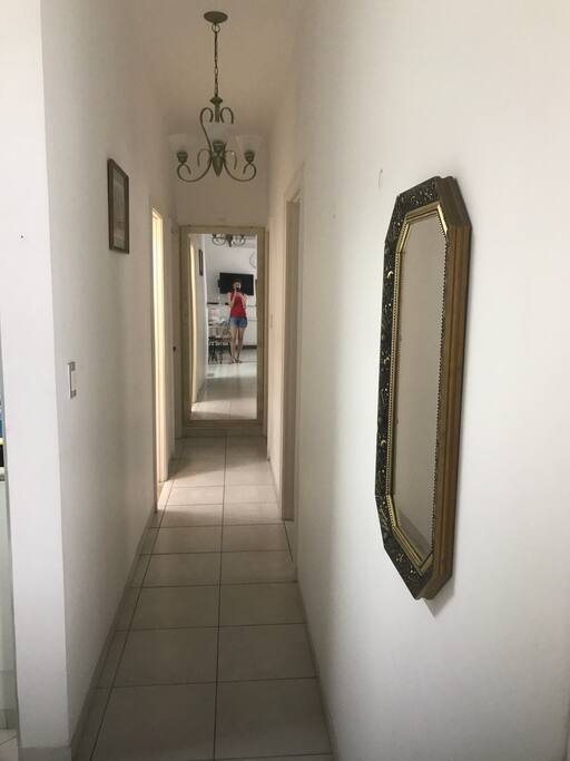 Corredor para a entrada dos quartos com espelhos decorativos.
