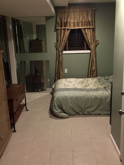 Bedroom with bed, dresser & two closets