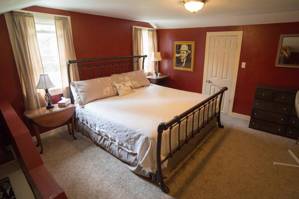 King size bed with TV in room, private stair case.