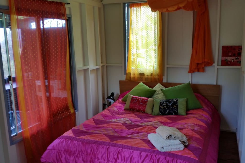 Colourful bedroom with good cross ventilation and afternoon sea breezes.