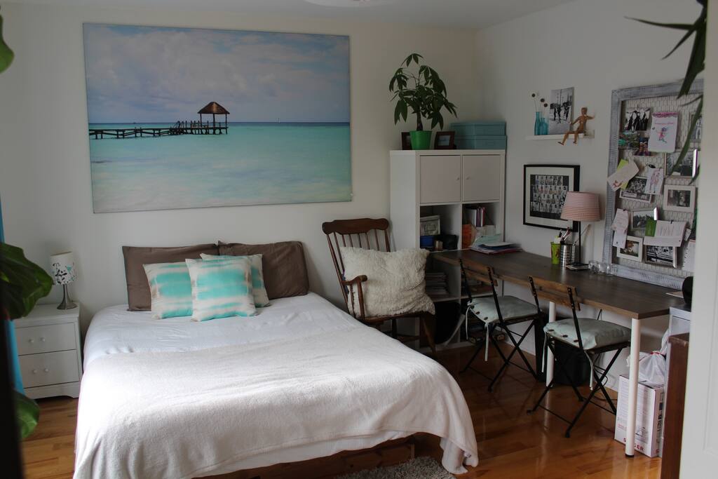 Chambre principale avec lit queen , bureau et accès au balcon arrière