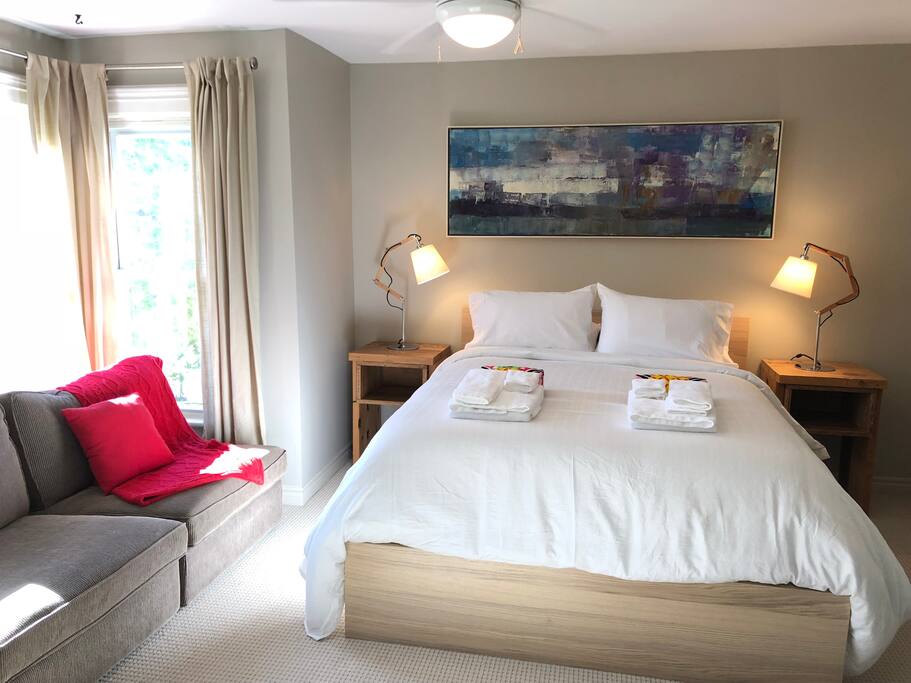 Private bedroom with Queen sized bed and sitting area with lake view.