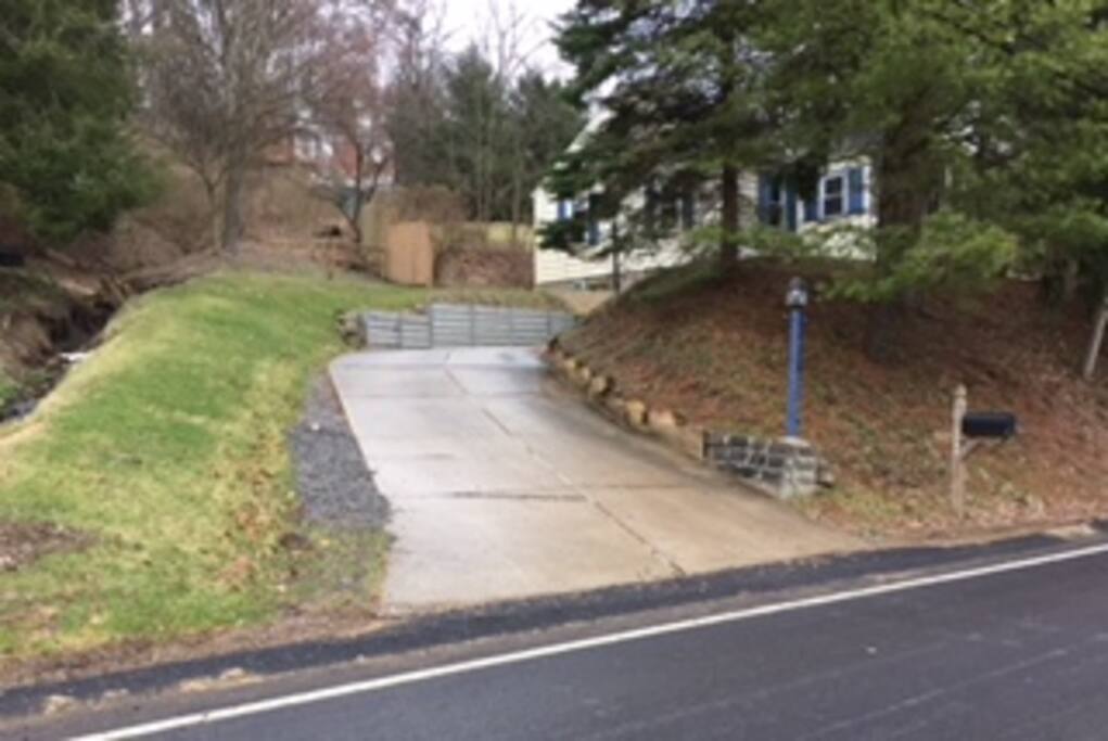Nice driveway and wooded view.